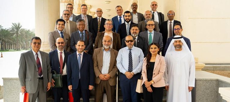 Engineering deans seated around the table at a council meeting